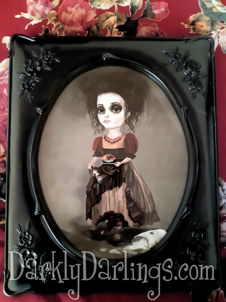 Helena Bonham Carter as Mrs Lovett holding a meat pie in a goth frame 